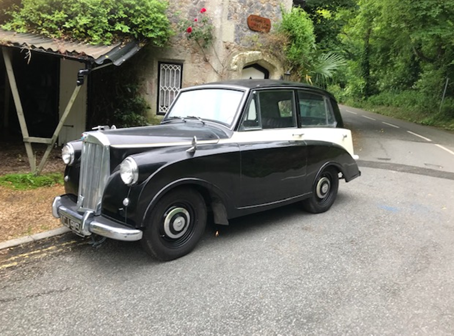 A black and cream Triumph Mayflower classic car.
