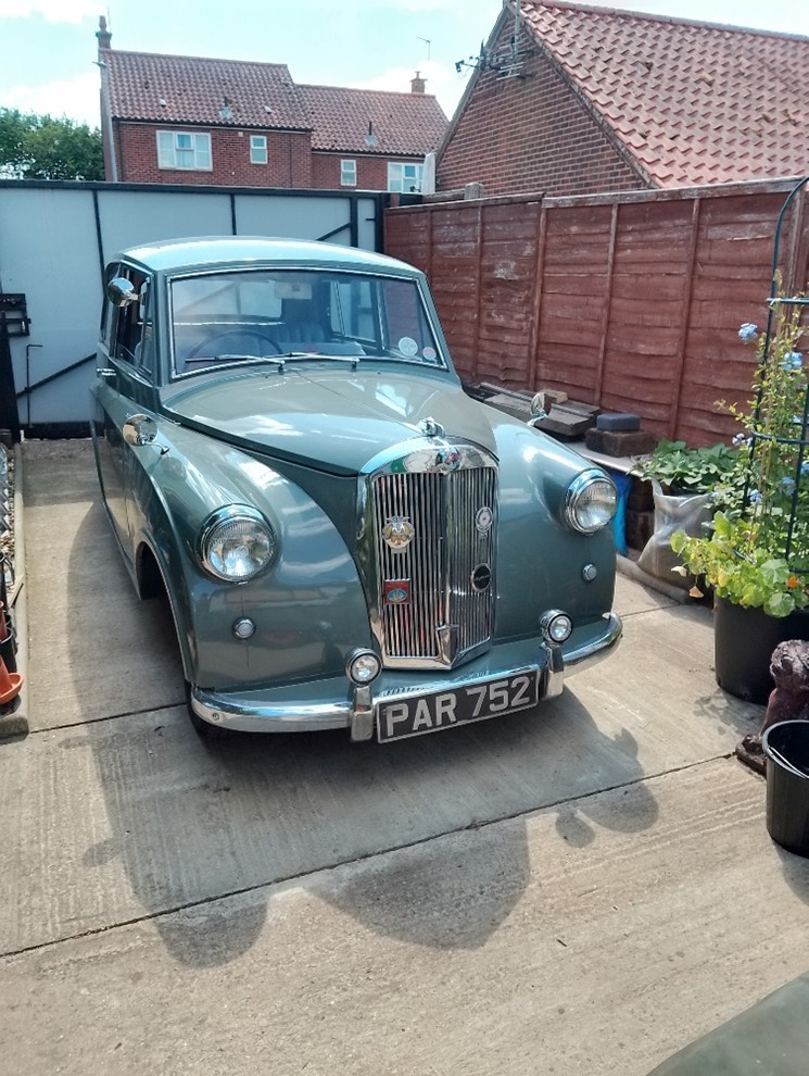 A green Triumph Mayflower classic car.